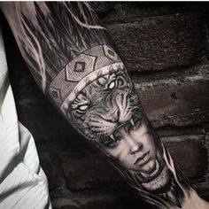 a man's arm with a tiger tattoo on it and an image of a woman