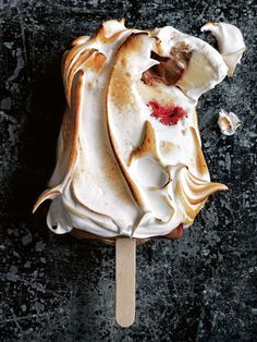 an ice cream sundae on a wooden stick