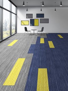 an empty room with yellow and blue carpeting