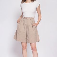 Vintage 80s/90s khaki cotton pleated shorts, with a high waist and a wide leg. Shown clipped on the model in the first two photos. Measurements and Condition: Fits like: Labeled size 12, see measurements below to ensure fit for modern sizing Fabric: Cotton Brand: Cenza, made in USA Condition: Good, with some faint 1/4" or smaller yellow spots on the front of the right leg and a couple on the lower front of the left leg, one on the back left seat, and three tiny white paint spots on the back left Retro Wide Leg Cotton Shorts, High Waist Khaki Pleated Skirt, Beige High Waist Cotton Shorts, Wide Leg Beige Cotton Shorts, Beige High-waist Cotton Shorts, Beige Wide Leg Cotton Shorts, Casual Wide Leg Pleated Shorts, Retro Wide Leg Spring Shorts, Khaki Relaxed Fit Wide Leg Shorts