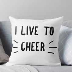 a pillow that says i live to cheer on the front and back of it with black lettering