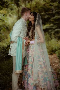 Bride in embellished pastel lehenga kisses her groom outdoors during couples portraits Pale Blue Outfit, Outdoor Hindu Wedding, Pastel Colour Scheme, Groom Colours, Pastel Lehenga, Indian Engagement, Indian Wedding Lehenga, Hindu Wedding Ceremony