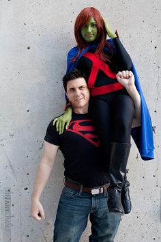 a man and woman dressed up as superheros