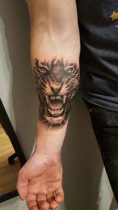 a man with a tiger tattoo on his arm