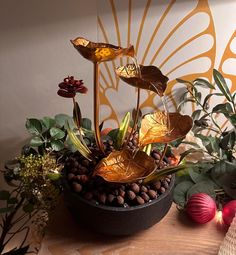 a vase filled with water and flowers on top of a table next to other plants