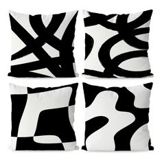 four black and white pillows sitting on top of each other