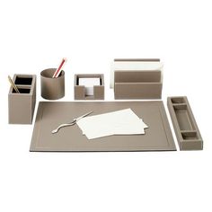 an assortment of office supplies including pen, paper and pencil holder on a white background