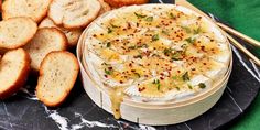 a plate with bread sticks and a bowl of dip