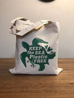 a tote bag that says keep the sea plastic free with an image of a turtle on it