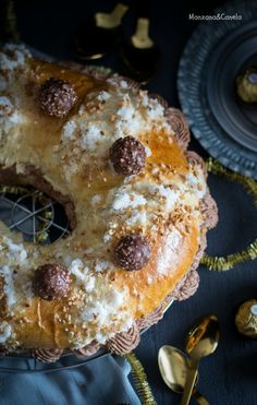 a large doughnut covered in chocolate and sprinkled with powdered sugar