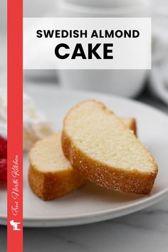 two slices of cake on a plate with whipped cream and strawberries in the background