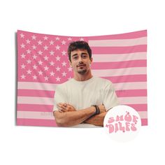 a man standing with his arms crossed in front of an american flag wall hanging tapestry