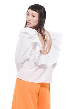 Our Cynthia Top is perfect for all your vintage styling dreams this summer. Inspired by the 80's, it features a darling ruffle neckline. Fabricated with a delicate 100% cotton lawn. We left an open tie back detail for something extra.