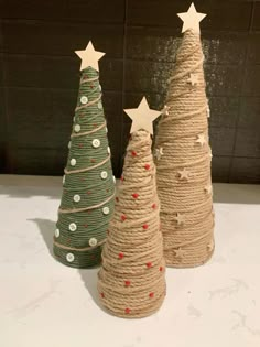 three small christmas trees made out of jute twine with stars on the top