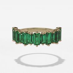 This is a stunning piece, perfect for adding style and flair to any look. Made using baguettes shaped emerald gemstones, it has a unique yet timeless aesthetic that will never go out of style. The halfway band design means this ring will wear comfortably and completely complement your existing jewelry collection. Whether it's worn on its own or stacked with other rings, this piece is sure to give you unforgettable color. The five millimeter width makes the ring just wide enough to be noticed wit Emerald Cut Eternity Band, Baguette Wedding Band, Sapphire Eternity Band, Trillion Diamonds, Elongated Cushion Cut, Ceylon Blue Sapphire, Engagement Ring Prices, Side Stone Engagement Ring, Timeless Aesthetic