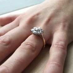 a woman's hand with a diamond ring on it