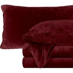 two pillows and a blanket on top of each other in red velvet color, set against white background