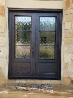 the front door to a home with two glass doors