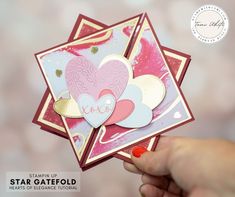 a hand holding up a card with hearts on it and the words star gatefold