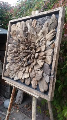 a large piece of wood sitting on top of a wooden easel