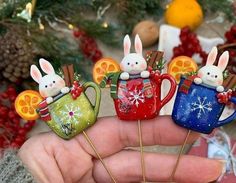 four little bunnies in mugs with orange slices on them