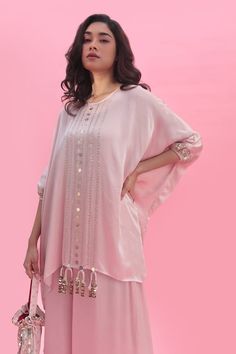 Pastel pink hand embroidered tunic featuring sequin embroidery. Paired with a coordinating flared pant. - Aza Fashions Pink Silk Kaftan With Dabka Work, Bollywood Style Embellished Pink Palazzo Set, Pink Bollywood Style Embellished Palazzo Set, Pink Silk Hand-embellished Sets, Hand Embellished Pink Silk Set, Pink Hand Embellished Silk Set, Embellished Pink Georgette Kurta, Pink Embellished Georgette Kurta, Pink Kaftan With Dabka Work For Navratri