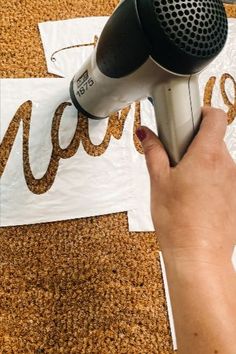 a person is using a hair dryer on the carpet