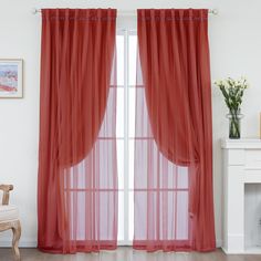 the curtains in this room are red and have sheer, pleated drapes on them