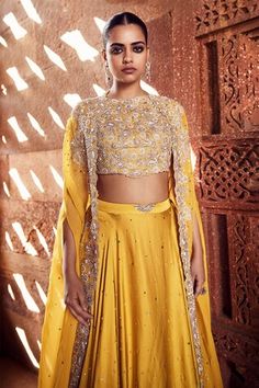 Mustard cape with silver dori, pearl, mirror and sequin embroidered cutwork border. Paired with floral embroidered blouse and lehenga. - Aza Fashions Organza Cape, Cape Lehenga, Dori Work, Organza Embroidery, Crepe Skirt, Crepe Skirts, Cut Work, Ethnic Wear, Embroidered Blouse