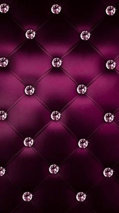 an upholstered wall with diamonds in the middle and dark purple fabric behind it