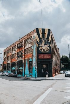 a large building with an artistic mural on the side of it's front entrance