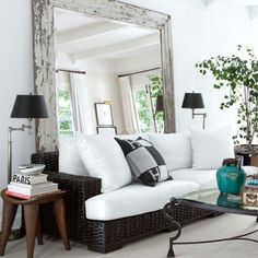 a living room filled with lots of white furniture