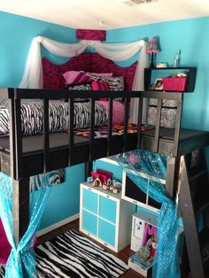 a bunk bed with zebra print and blue walls