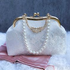 Add a touch of timeless sophistication to your bridal ensemble with our Elegant Floral Lace Bridal Hand Bag. This exquisite evening clutch is crafted from high-quality floral lace and adorned with vintage embroidery patterns, offering a classic yet unique look. The gold-toned hardware and kisslock closure add a touch of elegance, ensuring your essentials are securely held. Measuring 10 inches by 7.5 inches by 3.5 inches, this handbag is the perfect size for carrying your essentials on your speci Luxury Handheld Wedding Bag, Pearl Purse, Lace Purse, Purse Wedding, Bridal Purse, Wedding Bags, Wedding Hands, Gift For Wedding, Bridal Clutch