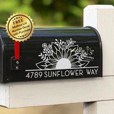 a black mailbox with a gold seal on it that says, 479 sunflower way