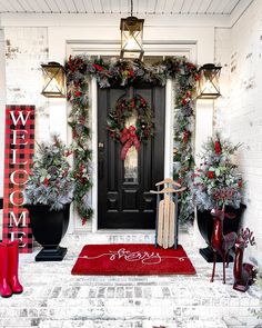 a front door decorated for christmas with wreaths and decorations