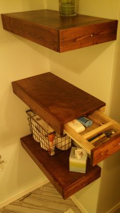 a bathroom with two shelves above the toilet