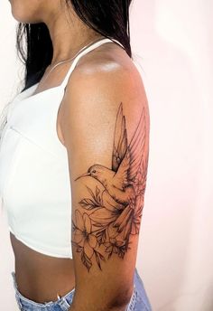 a woman with a bird tattoo on her arm