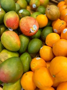 oranges, limes and other fruit are stacked on top of each other