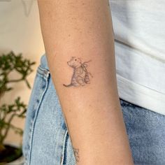 a small tattoo on the arm of a woman's left arm, with a cat