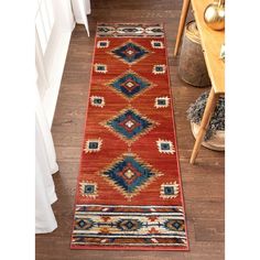 a red and blue runner rug on a wooden floor