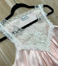 "Here we have luxurious authentic Christian Dior pink nightgown. This beautiful vintage gown features lace detail, soft satin material and side slits. Size: Petite - This could also fit a size Small/Medium as well (model shown is 6 feet tall and wears a 6/8 dress and 34DD bust and this nighty fit beautifully) 31.5-38\" in length 9.5\" arm openings 18\" across from underarm to underarm 24.5\" across the waist 29\" across the hips Lovely vintage condition - no flaws to mention! As always, shipping Cheap Pink Sleep Nightgown, Feminine Sleeveless Satin Sleepwear, Sleeveless Satin Sleepwear Feminine Style, Feminine Delicate Lace Sleeveless Sleepwear, Feminine Sleeveless Delicate Lace Sleepwear, Pink Satin Finish Sleepwear For Wedding Night, Sleeveless Delicate Lace Sleepwear For Wedding Night, Pink Satin Nightgown For Night, Pink Sleeveless Slip Dress For Wedding Night