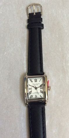 Vellacio women's silver rectangle watch, having a Rectangle white dial, displaying easy to read Roman Numeral Hours, all on a black leather band. This is a New unused Vintage Watch, works perfectly, ready to be cherished & enjoyed and keep you up with accurate on-time display! Measurements: Bezel/Case 1 1/8" x 3/4", Dial 3/4" x 5/8", Band Width 1/2" and fits a 5 1/2" up to a 7" wrist. We ship fast, the next business day for a quick delivery to you. May you have a wonderful time shopping, best wishes! Cheap Modern Rectangular Watch, Rectangle Watch, Hand Watch, Roman Numeral, Women's Watch, Women Wrist Watch, Quick Delivery, White Dial, Roman Numerals