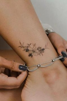 two women with tattoos on their legs and one has a flower tattoo on her ankle