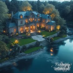 an aerial view of a large house with water and trees in the background at night