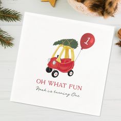 a card with an image of a red car and a christmas tree on the top