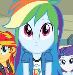 three different colored ponys standing next to each other