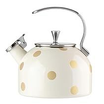 a white tea kettle with gold polka dots on it