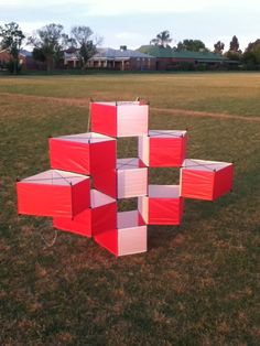 several red and white boxes sitting in the grass