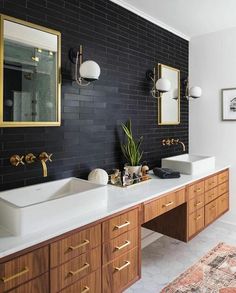 a bathroom with two sinks and mirrors on the wall